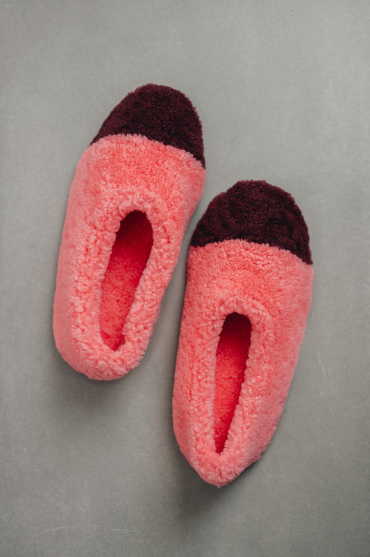 Birds eye view of ballerina style curly pink sheepskin slipper with burgundy toe point