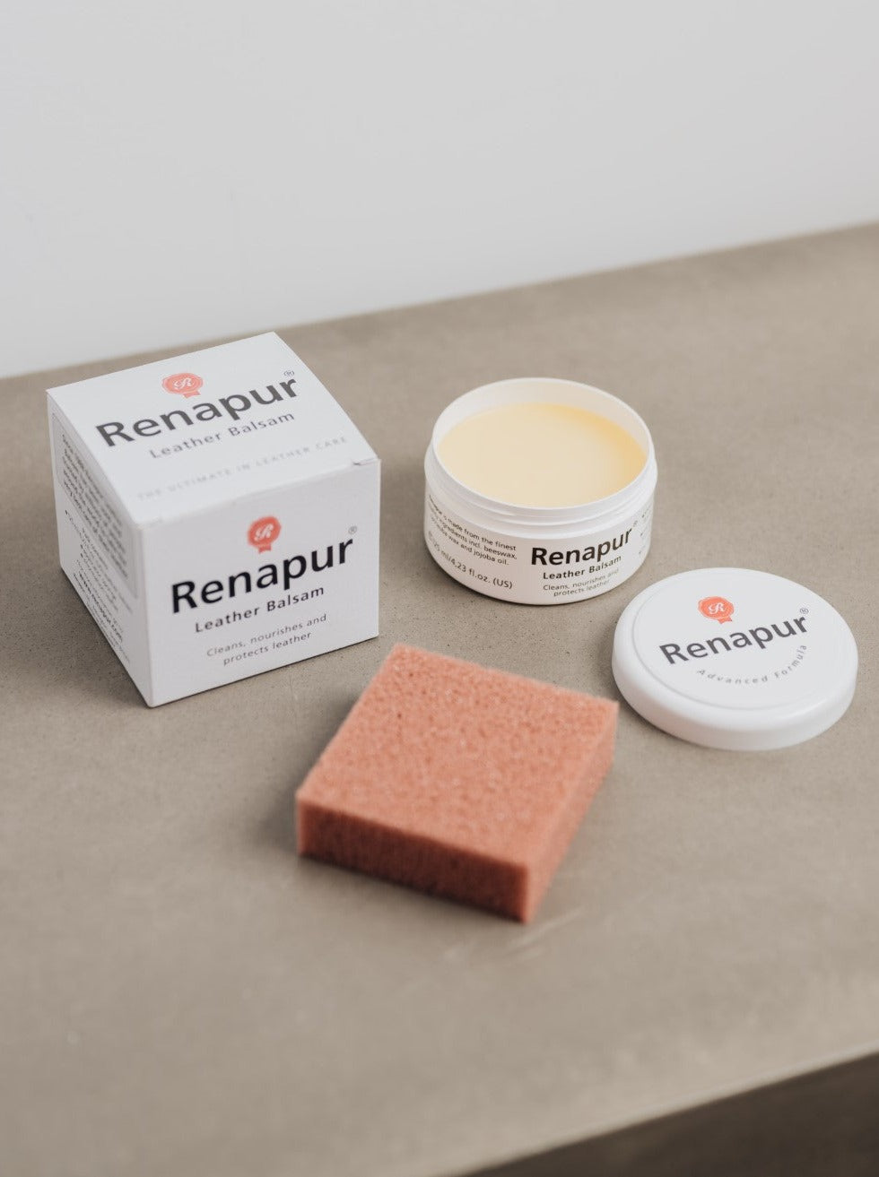 white box with Renapur branding, open pot of leather conditioner and orange/brown applicator sponge