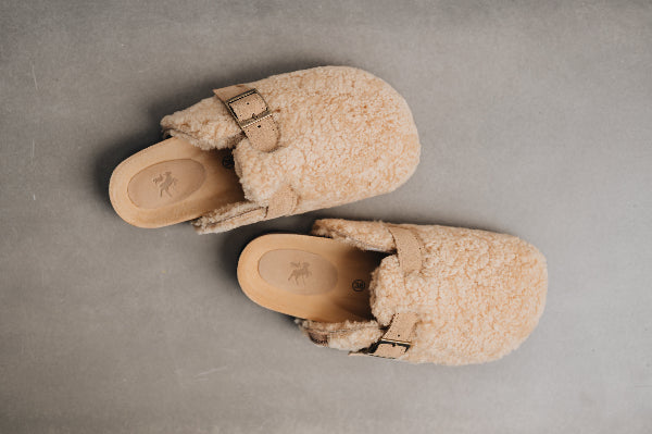 Birds eye view of curly sheepskin mule with adjustable strap