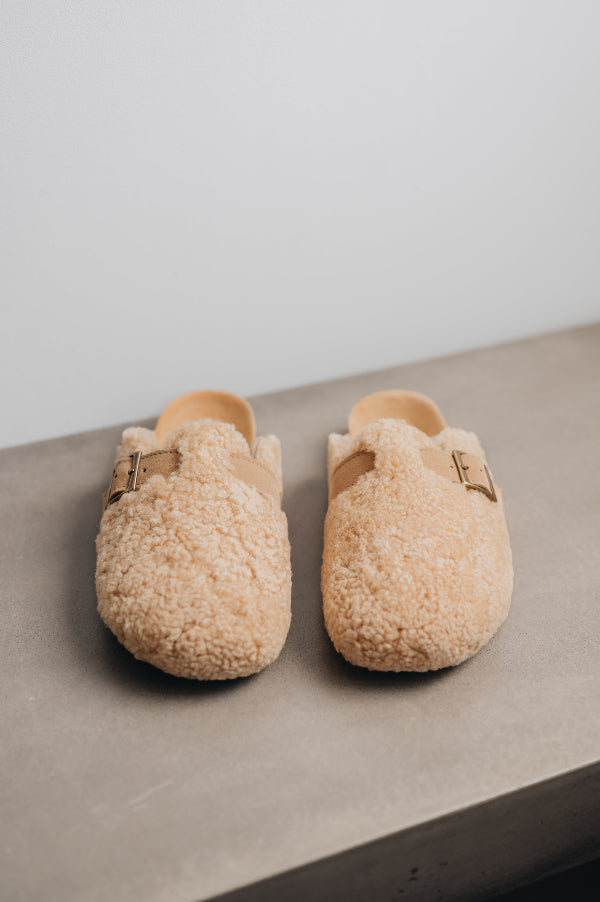 Front view of curly sheepskin mule with adjustable strap