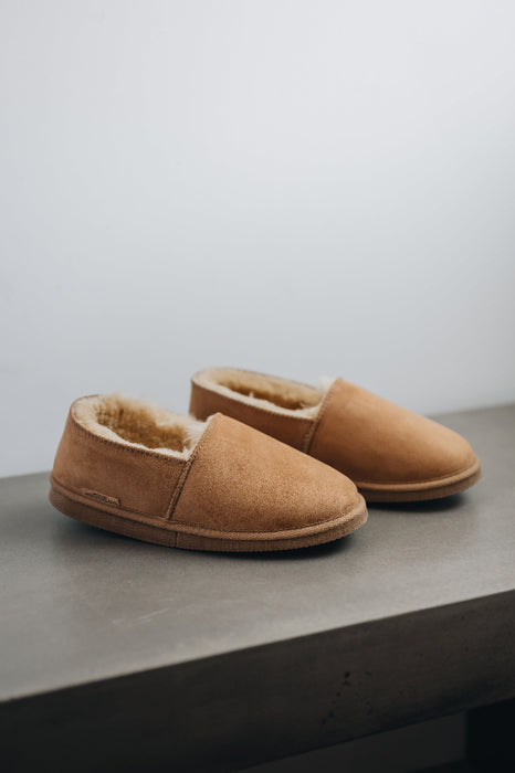 Side view of clean loafer style sheepskin slipper, hand crafted from Spanish merino sheepskin.