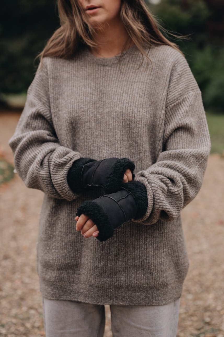lady wearing black fingerless mittens