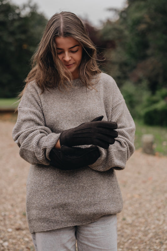 woman wearing sheepskin mittens brown