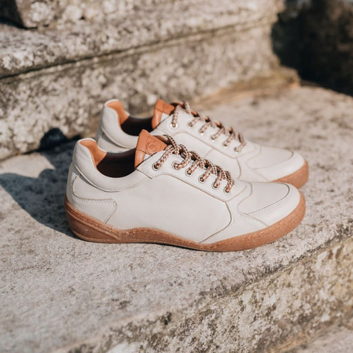 White leather trainer style shoe with rubber sole and insole. Made in  Europe.