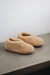 Top and side view of a camel coloured curly merino sheepskin boot slipper.