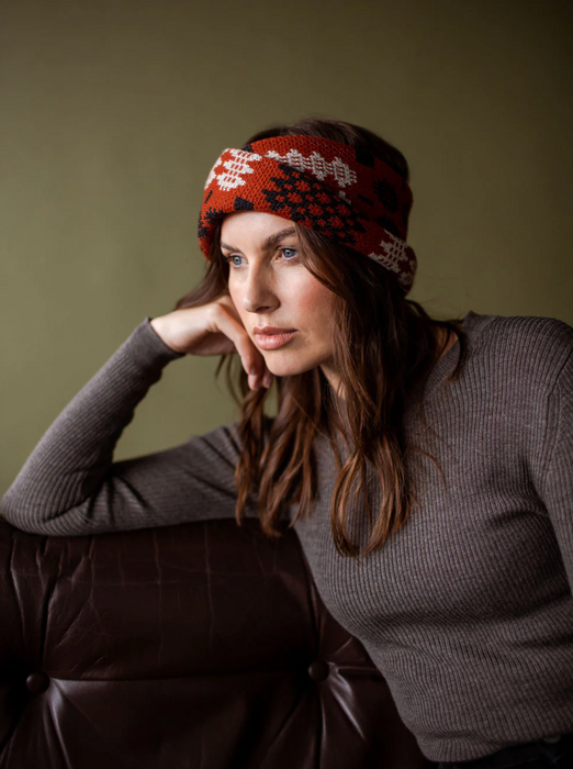 Open MABLI Brick Rusty Red Patterned Carthen Wrap. Super warm and stylish woven Wool wrap, designed to keep you kneck and head warm. Carthen Brick Rusty Red is a rich Red with charcoal grey, and white patterning. Styled around a model's head.