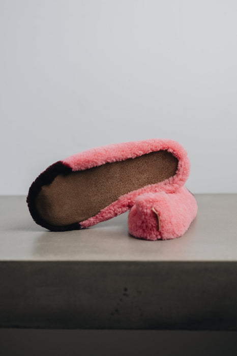 Pink curly sheepskin slippers with a beige suede sole
