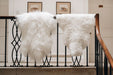 Icelandic Long & Short Wool Sheepskin Rugs in White, draped over a banister