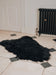 A deep black/brown Icelandic Sheepskin Long Wool Rug. Lying on a tiled floor.