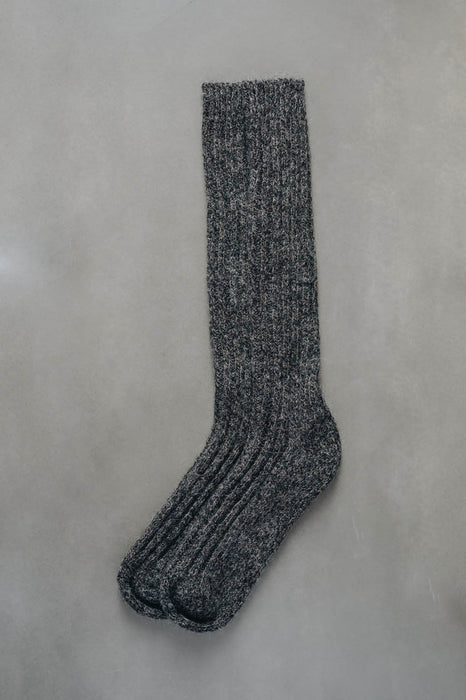 Brown natural merino wool sock on a light grey background