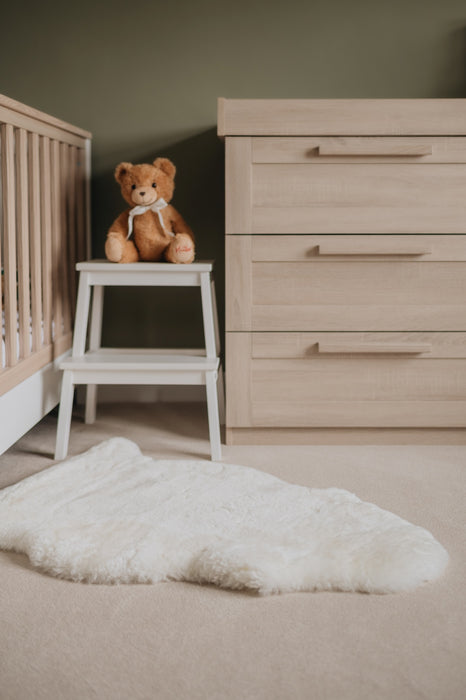 Milk coloured Sheepskin Nursing rug laid on the floor in a nursery playroom