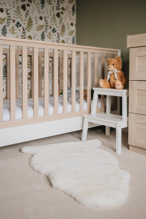 Milk coloured Sheepskin Nursing rug laid on the floor in a nursery playroom