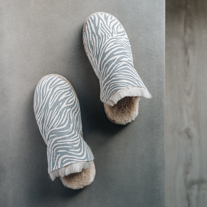 AW22 Veroncia Sheepskin Animal Print Slippers from Westmorland Sheepskin. Grey Zebra Print Slippers, with Sheepskin cuff and hard wearing brown sole.