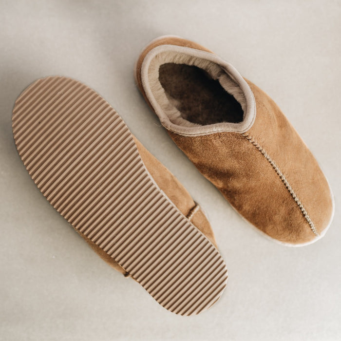 Outer sole and top down view of CADI Taupe Sheepskin Unisex Slipper, designed by Westmorland Sheepskins. Features a small branded cork tag sewn into outer trim.