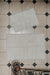 Two white designer sheepskin rugs on a tiled floor