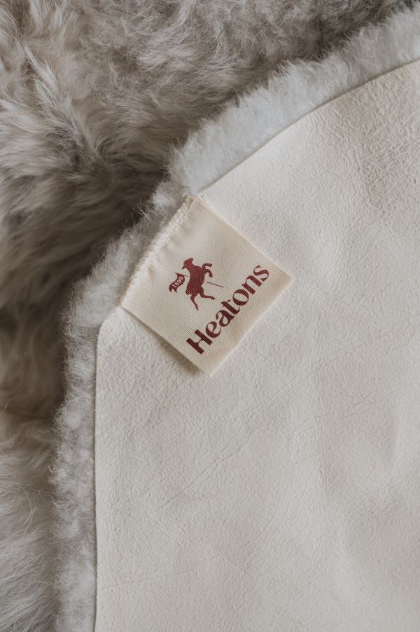 Close-up of a Heaton's label on a the suede back of a sheepskin rug
