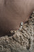 Close-up of a zipper on a brown fabric surface that is the bottom of a sheepskin beanbag.