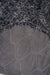 Close-up of a textured dark fabric with a honeycomb pattern on the back / underside of a grey / black sheepskin rug