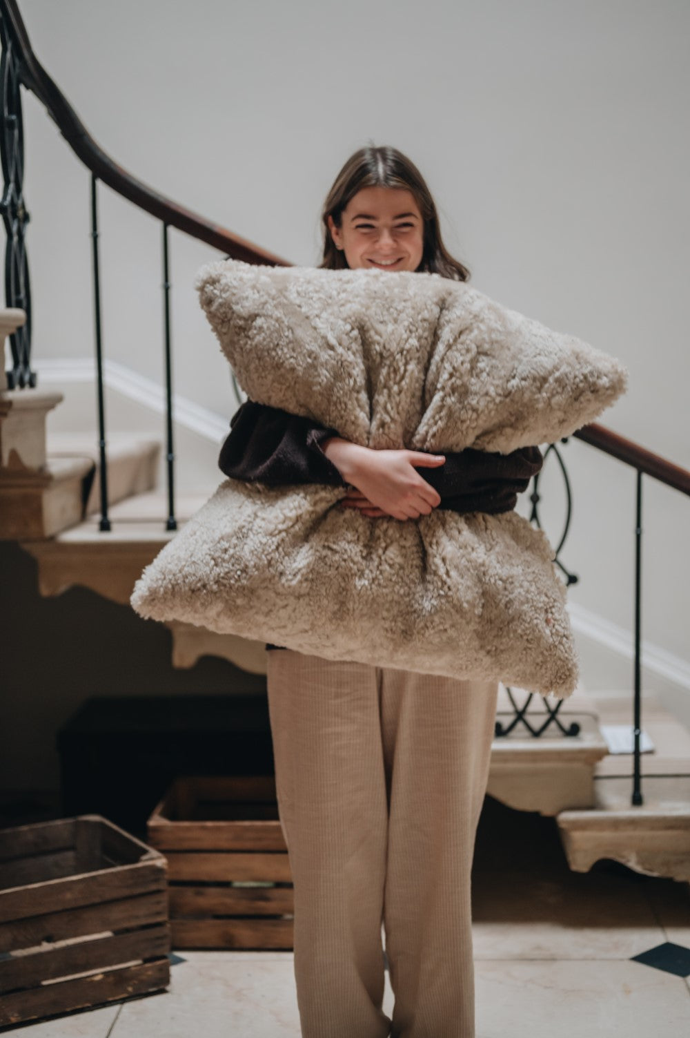 Sheepskin floor cushion being snuggled tight.