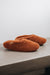 Side view of Curly merino sheepskin slip on slipper with curls on the outside and inside in a rich, warm rust colour.