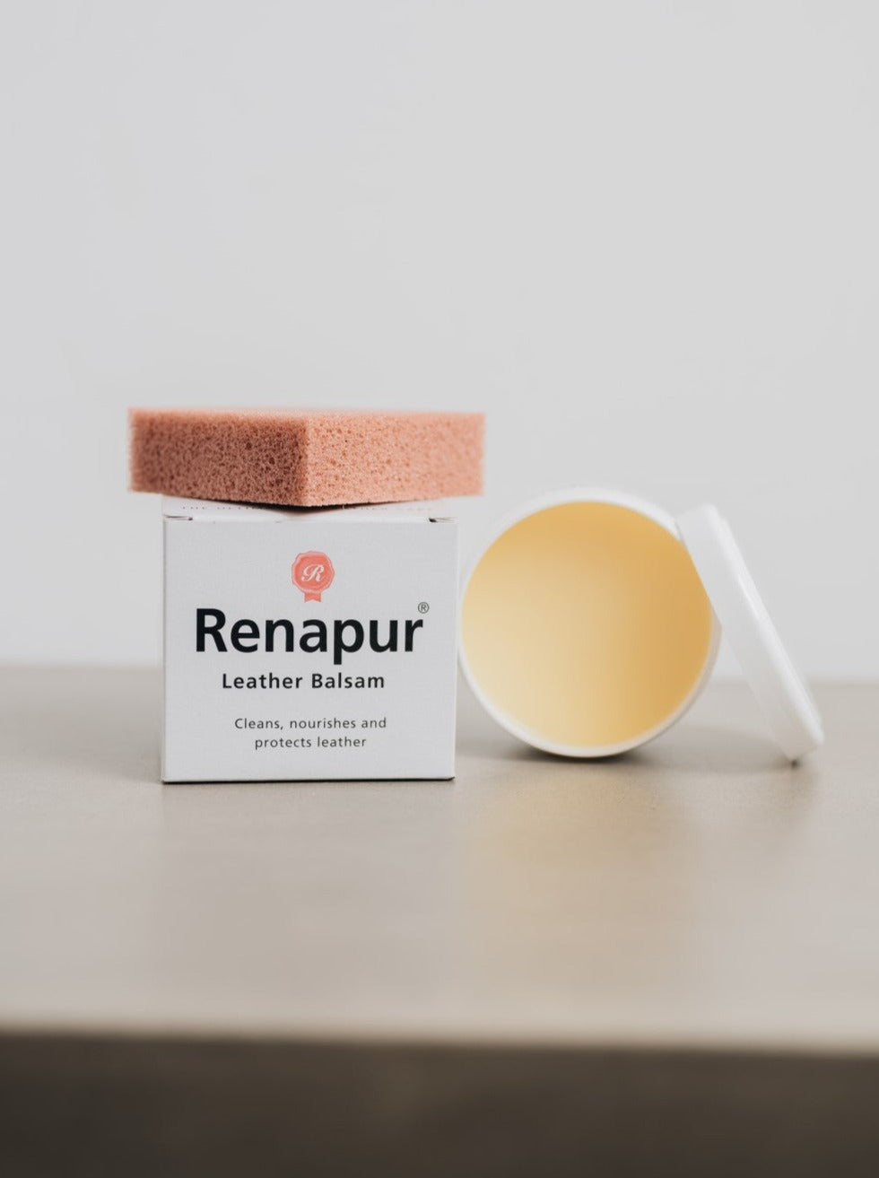 white box with Renapur branding, open pot of leather conditioner and orange/brown applicator sponge