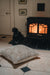 Big Sheepskin and leather backed Floor cushion. Infront of a fire in Oatmeal colour