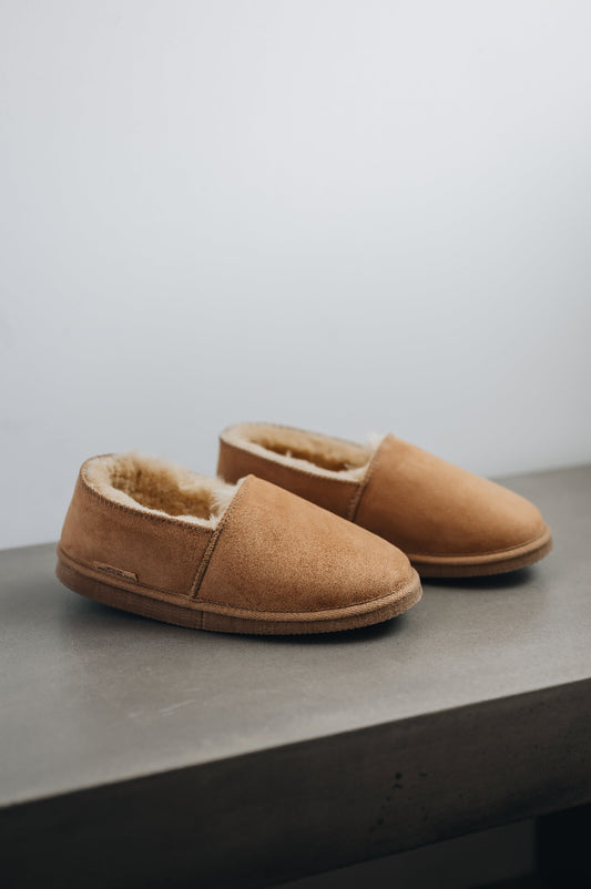 Side view of clean loafer style sheepskin slipper, hand crafted from Spanish merino sheepskin.