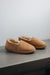 Side view of clean loafer style sheepskin slipper, hand crafted from Spanish merino sheepskin.