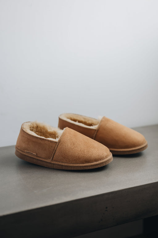 Side view of clean loafer style sheepskin slipper, hand crafted from Spanish merino sheepskin.