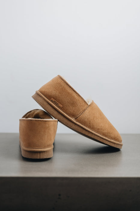 Side and rear view of clean loafer style sheepskin slipper, hand crafted from Spanish merino sheepskin.