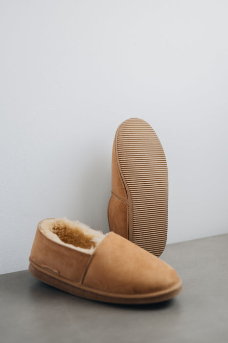 Bottom view of clean loafer style sheepskin slipper showing the sole, hand crafted from Spanish merino sheepskin.