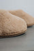 Close up of the toe post of a camel coloured curly merino sheepskin boot slipper.