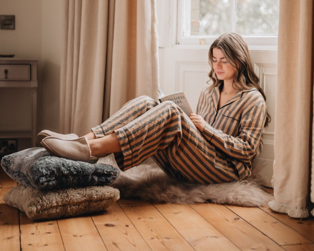 Women in Slippers reading a book.
