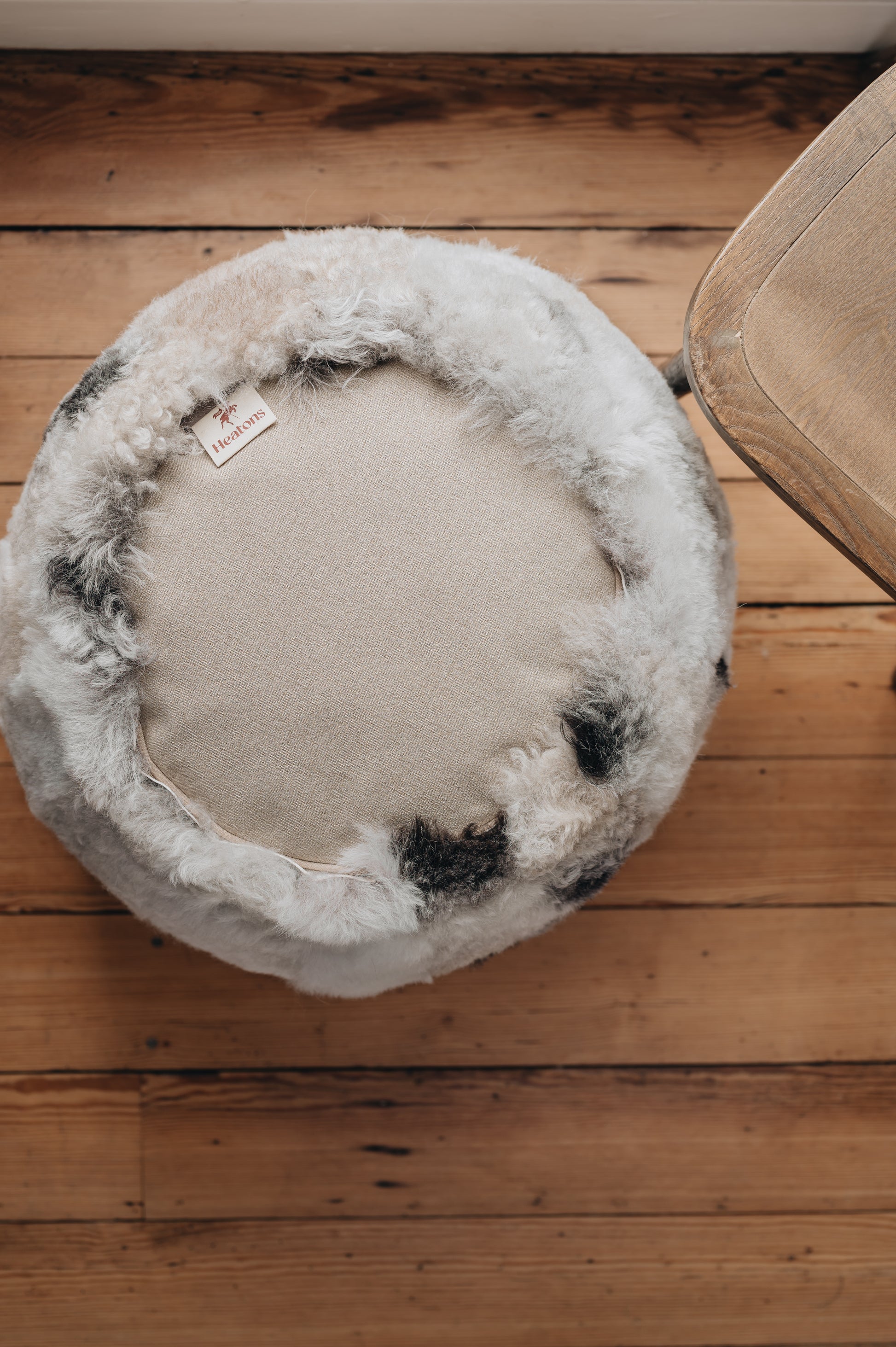 an icelandic sheepskin pouffe/footstool photographed upside down to show the woven base of the footstool