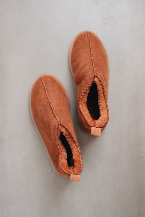 Birds eye view of Henry ankle-high sheepskin slipper showing plush natural sheepskin wool inside