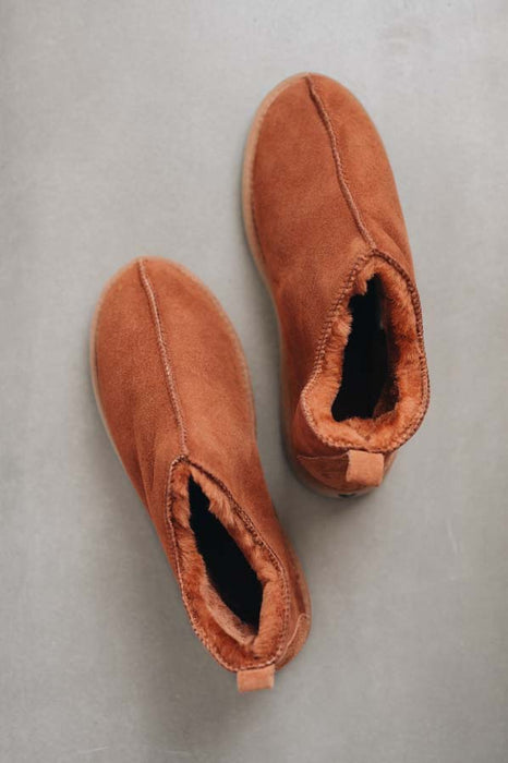 Birds eye view of Hetty ankle-high sheepskin slipper showing plush natural sheepskin wool inside