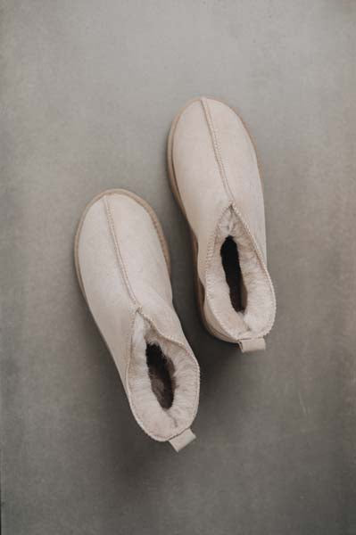Birds eye view of Hetty ankle-high sheepskin slipper showing plush natural sheepskin wool inside