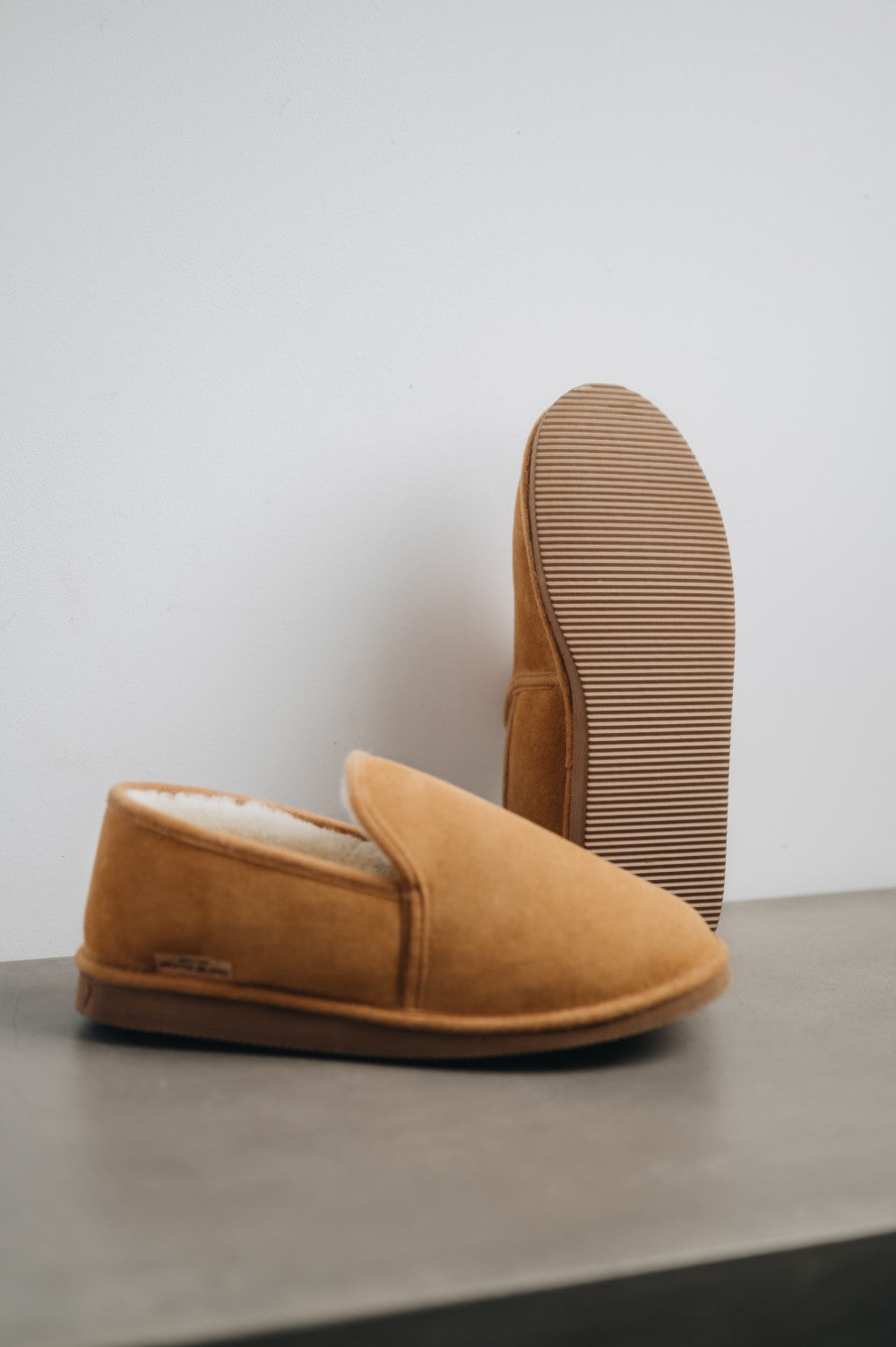 Regina is a thick sheepskin ankle high slipper with a durable sole