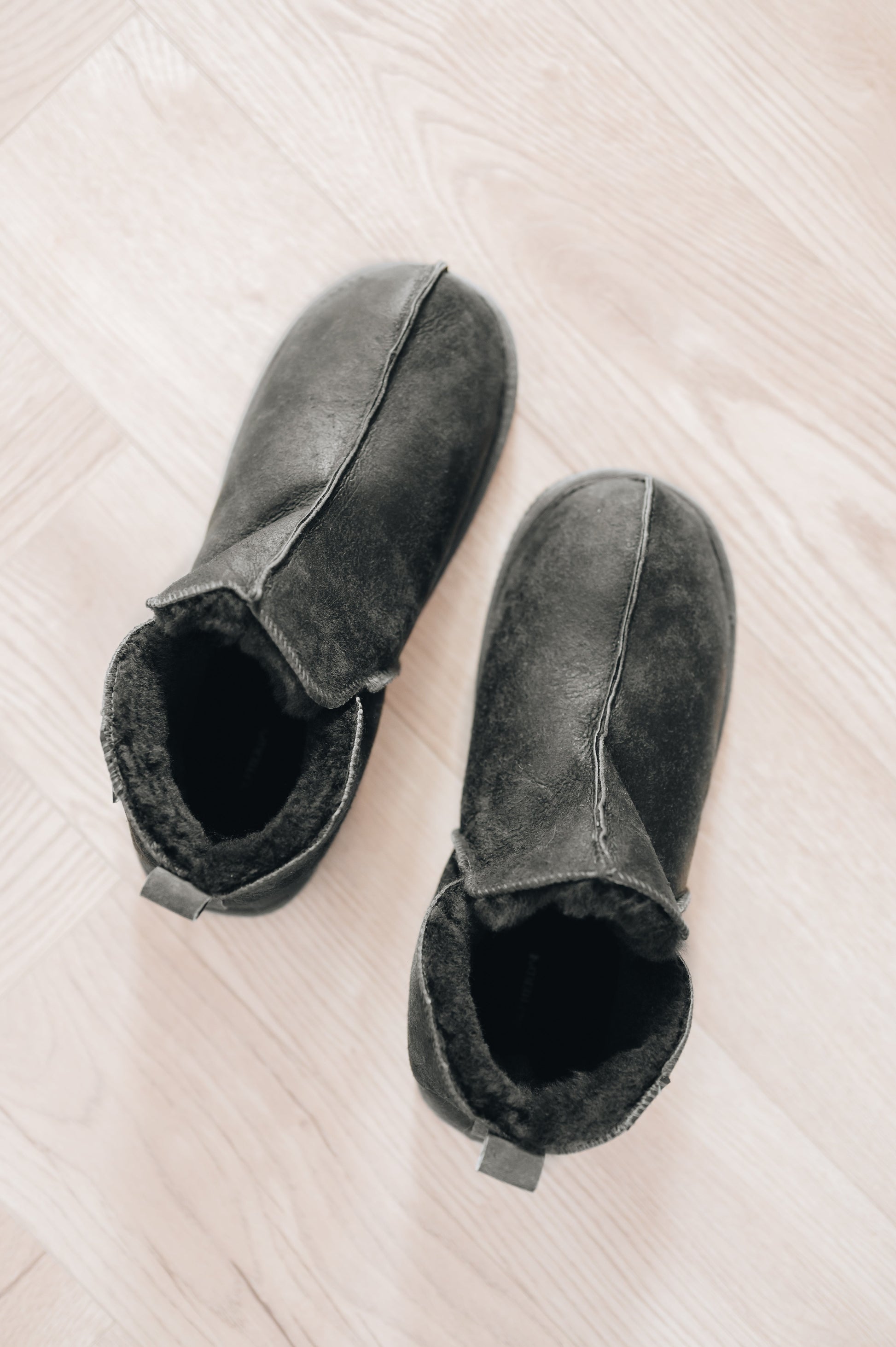 mens sheepskin slippers in a dark grey colour, shown from above
