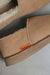 Close up of tan coloured loafer style sheepskin slipper with orange cork label showing the Heatons brand