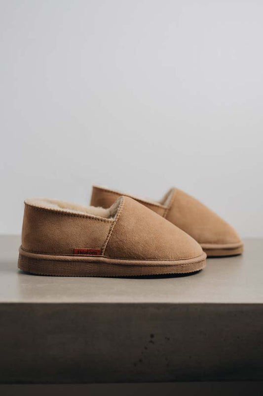 Side view of clean loafer style sheepskin slipper, hand crafted from Spanish merino sheepskin.