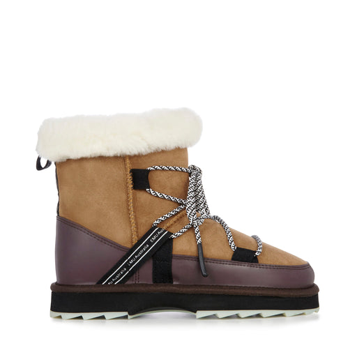 Women's tan sheepskin outdoor boots with patterned lacing and branded details