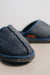 Close up of denim covered slip on style sheepskin slipper with orange cork label showing the Heatons brand