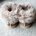 Sheepskin cuff on Orla Stone Children's Sheepskin Hard Soled Slippers. A Sheepskin Slipper with a cuff of Stone colour Sheepskin around the ankle, with a hard wearing outer sole.
