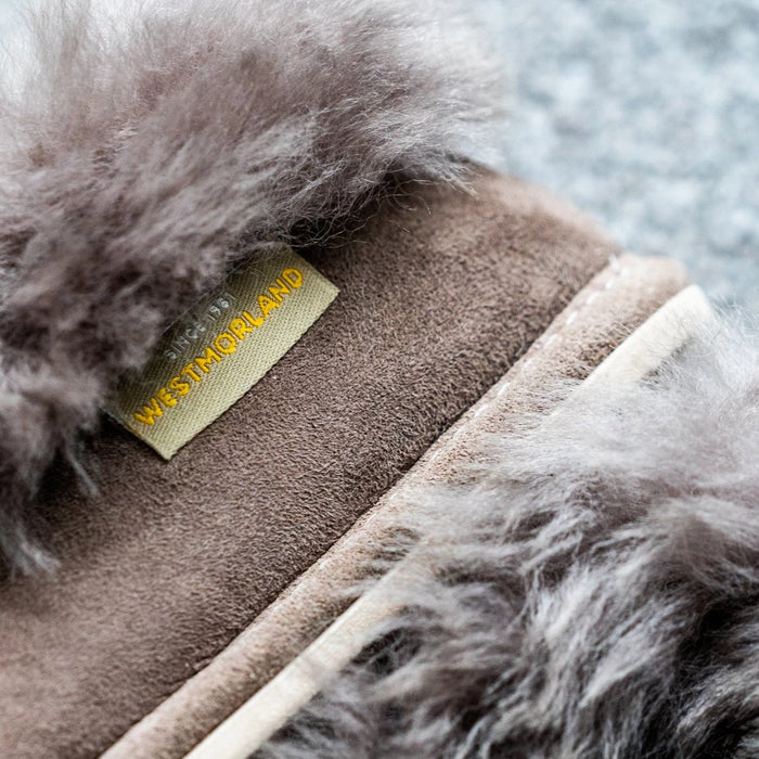 Westmorland Sheepskins branded label on Orla Stone Children's Sheepskin Hard Soled Slippers. A Sheepskin Slipper with a cuff of Stone colour Sheepskin around the ankle, with a hard wearing outer sole.