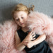 Little girl on Curly pink Sheepskin Rug