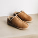 Upper view of CADI Taupe Sheepskin Unisex Slipper, designed by Westmorland Sheepskins. Features a small branded cork tag sewn into outer trim.