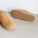 Outer sole and upper view of CADI Tan Sheepskin Women's Slipper, designed by Westmorland Sheepskins. The ankle has a contemporary Orange Foil look. Features a small branded cork tag sewn into outer trim.