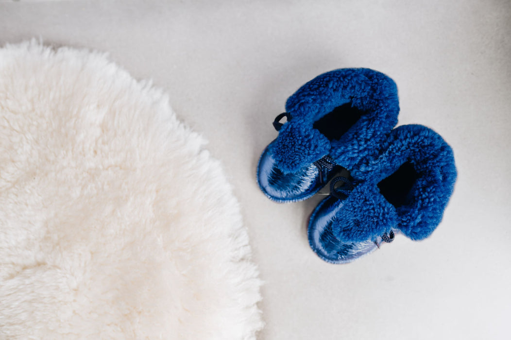 Top down view of Westmorland Sheepskins Soft Soled Metallic Blue foil Baby Sheepskin Boots with a blue Sheepskin Cuff and laces.