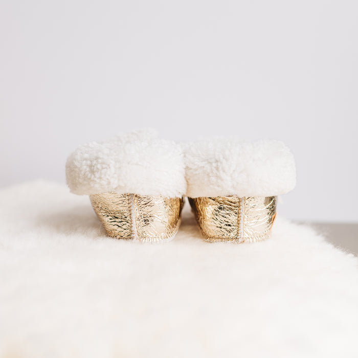 Back view of Westmorland Sheepskins Soft Soled Metallic Platinum (light gold) foil Baby Sheepskin Boots with a white Sheepskin Cuff and laces.